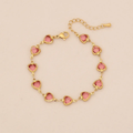 Pulsera dorada de corazones rosado