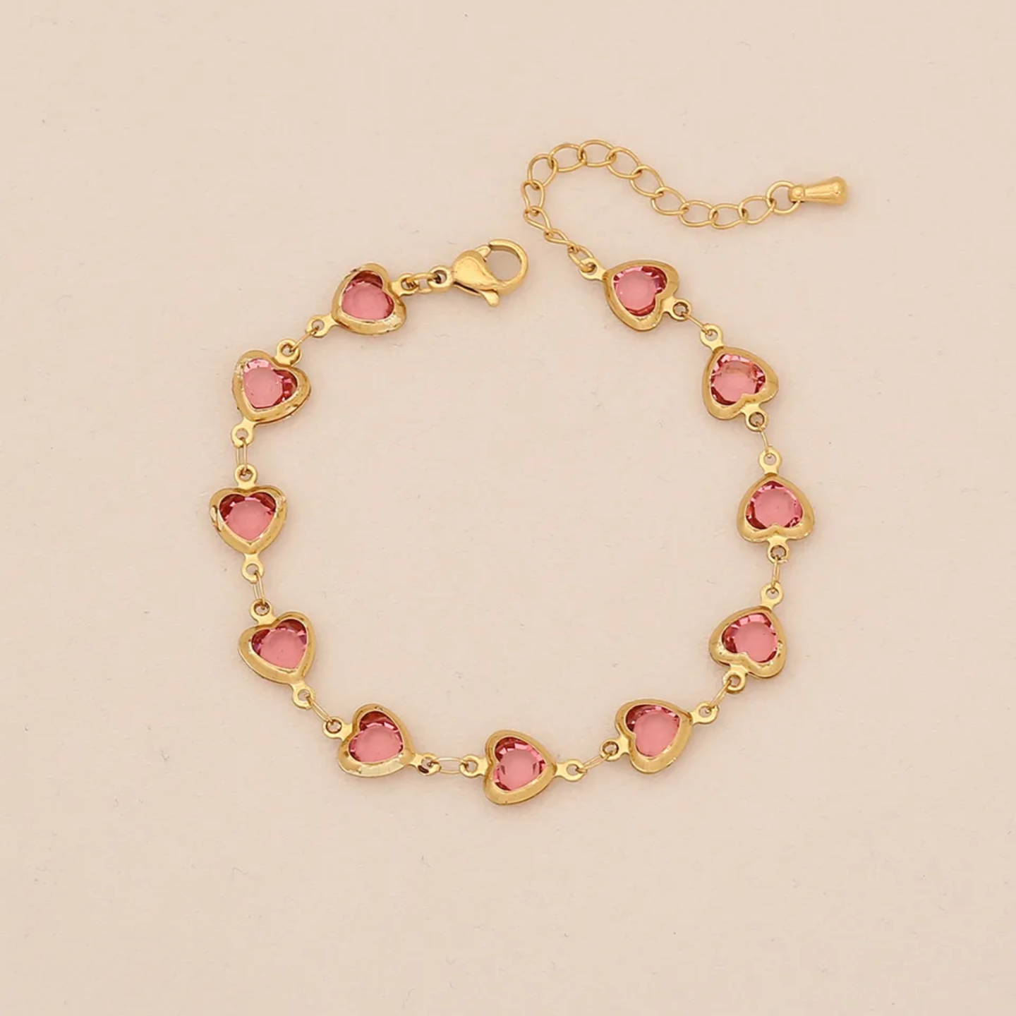 Pulsera dorada de corazones rosado