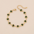 Pulsera dorada de corazón verde