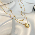 Cadena Doble plana y corazón dorado